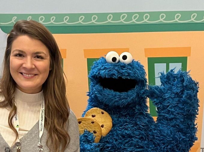 Sydney Forde poses for a photo with Cookie Monster.