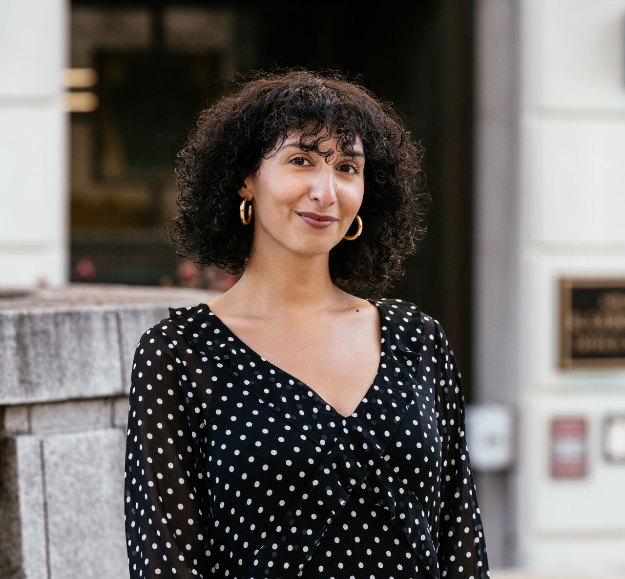 portrait of Elizabeth Estrada in front of a building.