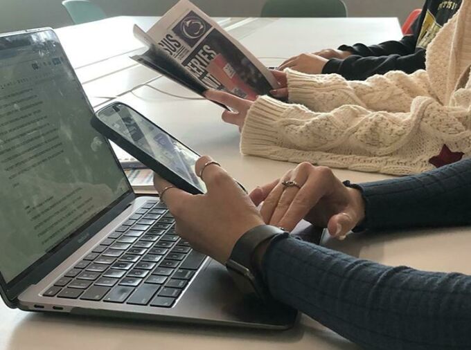 laptop, phone, newspaper, hands