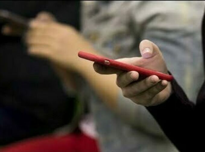 hand holding phone in red case