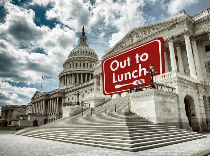US Capitol Building with "Sorry, we're closed" sign hanging from roof.