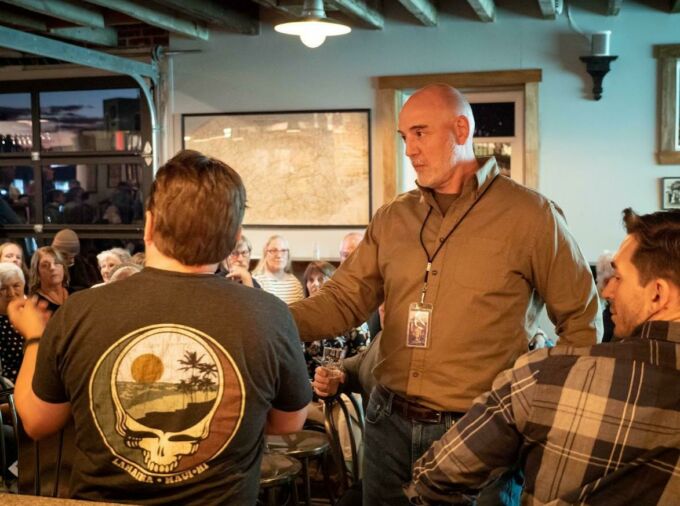 Journalist Tim Lambert talking with community members