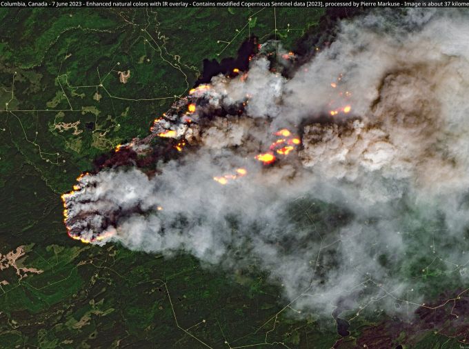 modified satellite image of flames and billowing smoke among a green forest landWest Kiskatinaw River Wildfire, British Columbia, Canada - 7 June 2023.